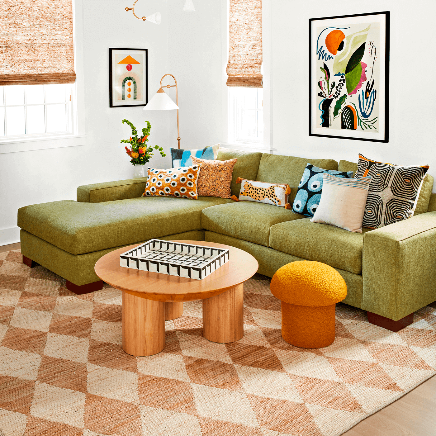كنب زاوية أخضر مريح في غرفة معيشة عصرية مع طاولة خشبية ووسائد ملونة